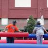 Couple of kids having fun on this jousting game