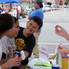 Kids having fun with  face painting looks like the Hardee Wild Cats Paw on their faces