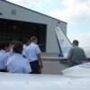 Pilot Carl Saunders goes over Pre-Fight inspection of plane with his group