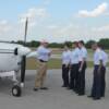 Pilot Mike Wilkerson goes over Pre-Fight inspection of plane with his group