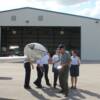 Pilot Carl Saunders goes over Pre-Fight inspection of plane and how everything works with his group