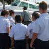 Cadets watch Pilot Carl Saunders check one of the engine compartments