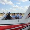 Pilot Dale Johnson  goes over Pre-Fight inspection of plane and how everything works at the back of plane with his group