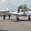 Pilot Carl Saunders boards his  twin engine plane