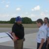 Pilot Dale Johnson goes over Pre-Fight inspection of plane with his group