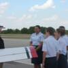 Pilot Dale Johnson goes over Pre-Fight inspection of plane with his group