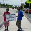 Timothy and Tayquan holding signs on US 17 South 