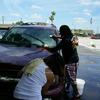 Rosa and Dillot washing SUV