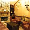 This is Lavon's office it's really nice fire place, wall mountings, leather chairs and sofa