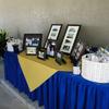 This is a gift table where photos of Lavon & Linda Cobb on some of their early projects and their was a gift basket where  guests got a T-shirt some pens and other things to take with them.