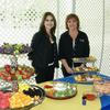 Lydia Quintana, and Donna Harris of L Cobb Construction serving with a smile.  Their was some really good food on hand.