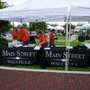 Main Street Wauchula booth girlling hot dogs and sausages