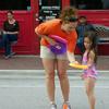  Kimberly showing one of the kids how to throw a frisbee 
