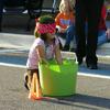This little girl is fisihing for some green four leaf clovers all part of a game their palying on Main Street.