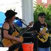 Missy Raguth singing and playing guitar