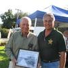 Previous County Commissioner Milton Lanier holding courtyhouse picture with son Deputy Sheriff Arnold Lanier